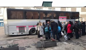 Moving refugees by bus in Kiev